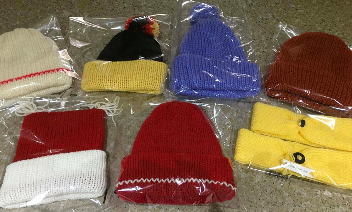 woollen hats, headbands, ear warmers and drink koozie winter warmers sold by Shirley's Knitting Shop